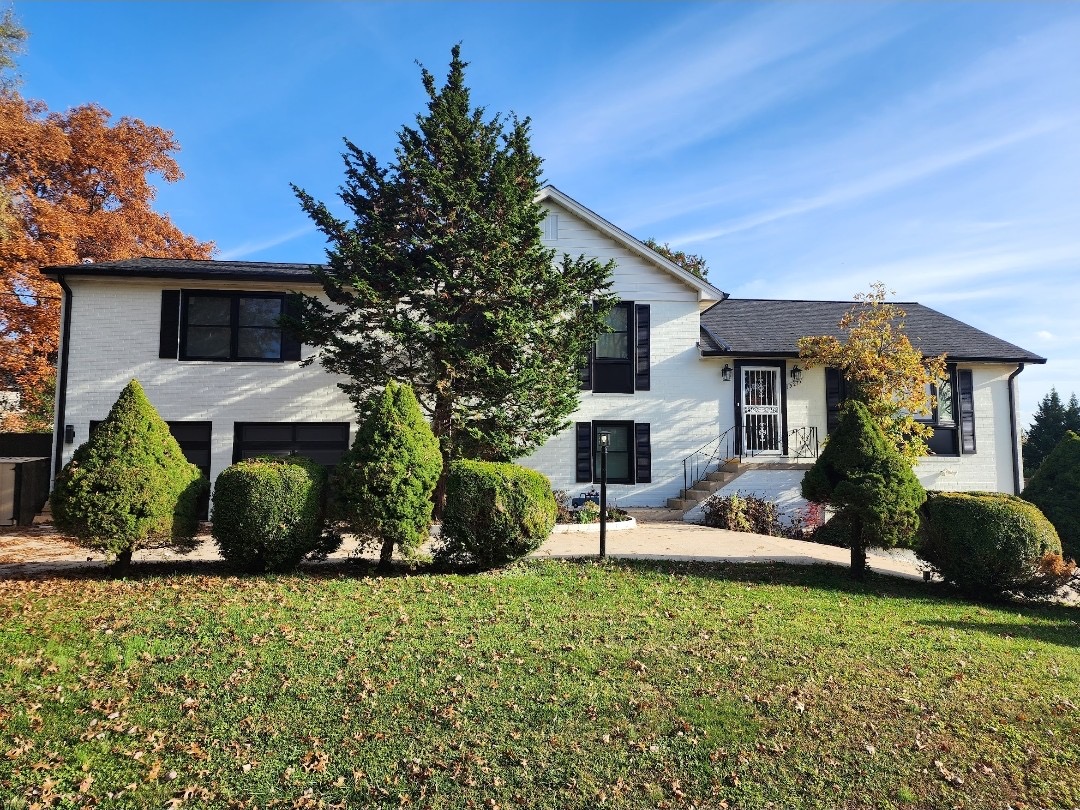 White painted brick home – completed roof